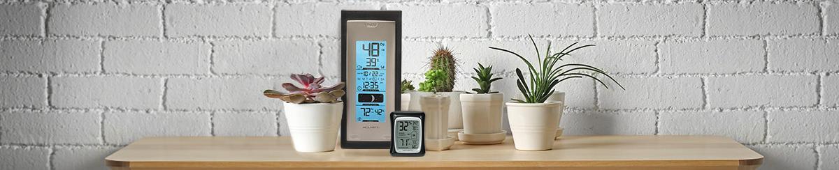 AcuRite hygrometers on a table top with potted plants