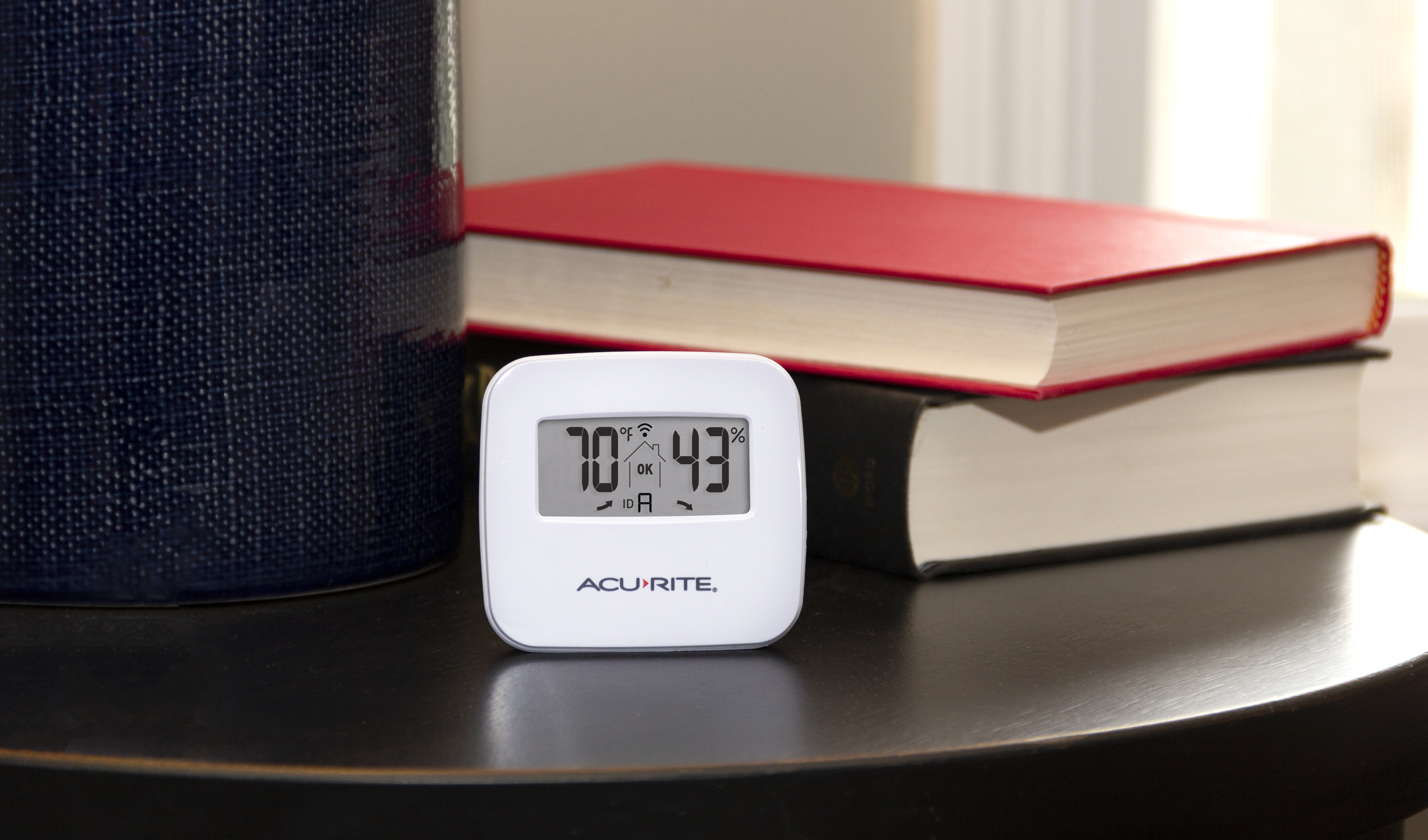 AcuRite temperature and humidity sensor sitting on table