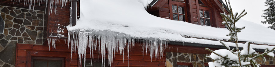 Snow and ice hanging over roof gutter
